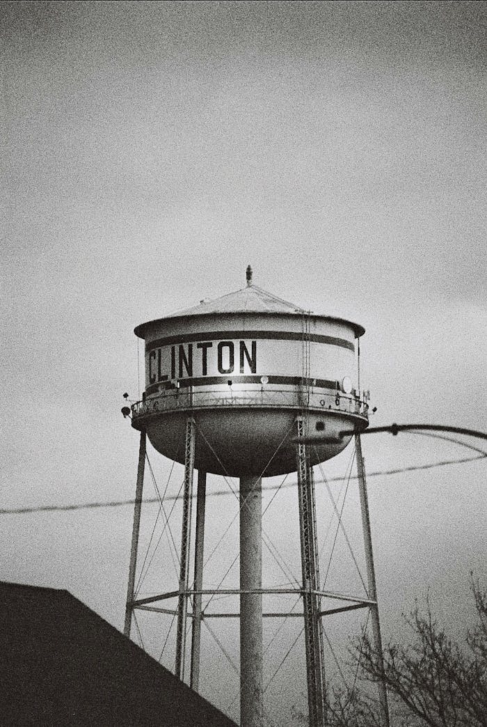 Monochrome image of the Clinton water tower standing tall against a cloudy sky in Illinois.
